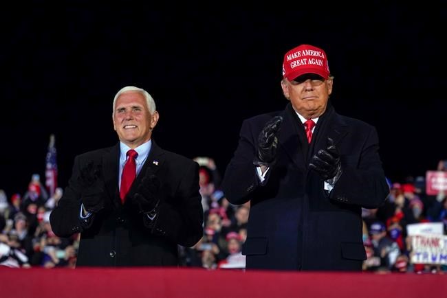 President Donald Trump arrives for a campaign rally at Gerald R. Ford International Airport, Monday, Nov. 2, 2020, in Grand Rapids, Mich., with Vice President Mike Pence (AP Photo/Evan Vucci)