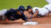 Cleveland Indians' Jose Ramirez, left, dives to first base to beat the tag of Detroit Tigers first baseman Jeimer Candelario during the seventh inning of a baseball game in Detroit, Saturday, Aug. 15, 2020. (AP Photo/Paul Sancya)