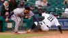 Detroit Tigers left fielder JaCoby Jones (21) slides safely into third base under the tag of Minnesota Twins third baseman Josh Donaldson (20) in the seventh inning of a baseball game in Detroit, Saturday, May 8, 2021. (AP Photo/Paul Sancya)