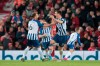 Brighton's Lewis Dunk, right, celebrates after scoring during the English Premier League soccer match between Liverpool and Brighton at Anfield Stadium, Liverpool, England, Saturday, Nov. 30, 2019. (AP Photo/Jon Super)