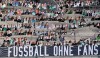 Thousands of cardboards with photos of Borussia Moechengladbach soccer fans are displayed on the stands at he stadium in Moenchengladbach, Germany, Tuesday, Aug. 4, 2020. A banner reads 