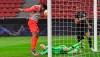 Young Boys' Jordan Siebatcheu, left, scores his side's opening goal against Leverkusen's goalkeeper Niklas Lomb during the Europa League round of 32, 2nd leg soccer match between Bayer 04 Leverkusen and Young Boys Bern in Leverkusen, Germany, Thursday, Feb. 25, 2021. (AP Photo/Martin Meissner, POOL)