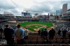 The Seattle Mariners and Minnesota Twins stand along the baselines and fans stand for the national anthem for the home opener baseball game at Target Field Thursday, April 8, 2021, in Minneapolis. Due to COVID-19 restrictions, only 10,000 fans are allowed in the ballpark. (AP Photo/Bruce Kluckhohn)