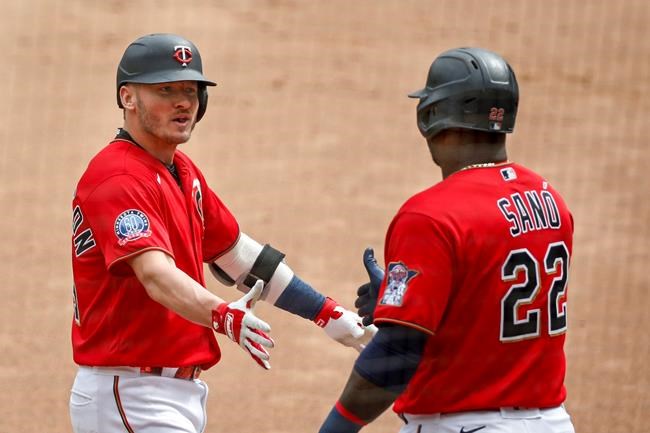 Minnesota Twins' Josh Donaldson celebrates with Miguel Sano (22) his solo home run against the Detroit Tigers in the first inning of the first game of a baseball doubleheader Friday, Sept. 4, 2020, in Minneapolis. (AP Photo/Bruce Kluckhohn)