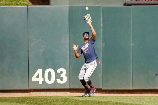 Minnesota Twins' Byron Buxton fields a ball in an intrasquad baseball game Monday, July 13, 2020, in Minneapolis. (AP Photo/Bruce Kluckhohn)