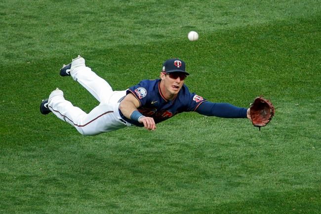 Minnesota Twins right fielder Brent Rooker dives for but misses a ball hit by Detroit Tigers' Jonathan Schoop for an RBI triple during the third inning of the second game of a baseball doubleheader Friday, Sept. 4, 2020, in Minneapolis. (AP Photo/Bruce Kluckhohn)