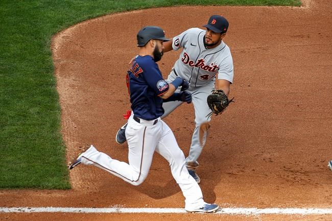 Detroit Tigers first baseman Jeimer Candelario, right, tags out Minnesota Twins' Marwin Gonzalez on a ground ball in the fourth inning of the second game of a baseball doubleheader Friday, Sept. 4, 2020, in Minneapolis. (AP Photo/Bruce Kluckhohn)