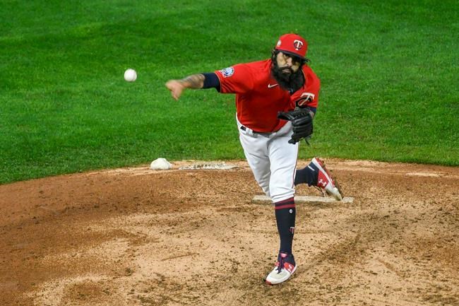 Minnesota Twins pitcher Sergio Romo throws to a Cleveland Indians batter during the eighth inning of a baseball game Friday, Sept. 11, 2020, in Minneapolis. The Twins won 3-1. (AP Photo/Craig Lassig)