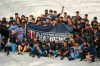 Members of the AL Central champions Minnesota Twins pose for a photo in the rain after their baseball game with the Cincinnati Reds, Sunday, Sept. 27, 2020, in Minneapolis. Twins clinched the AL Central championship with the Chicago White Sox's loss. The Reds won 5-3. (AP Photo/Craig Lassig)