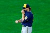 Milwaukee Brewers' pitcher Corbin Burnes pulls up his jersey over his face after giving up a walk to Minnesota Twins' Max Kepler in the fifth inning of a baseball game Tuesday, Aug. 18, 2020, in Minneapolis. (AP Photo/Jim Mone)