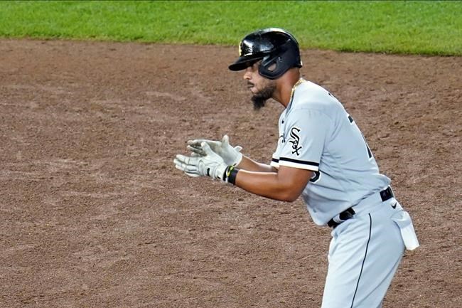 Chicago White Sox's Jose Abreu applauds after his two-run double off Minnesota Twins' Tyler Clippard in the sixth inning of a baseball game Monday, Aug. 31 2020, in Minneapolis. (AP Photo/Jim Mone)