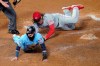 Minnesota Twins' Marwin Gonzalez, left, scores on a wild pitch by Cincinnati Reds' Luis Castillo, right, who covers the plate during the fourth inning of a baseball game Saturday, Sept. 26, 2020, in Minneapolis. The Twins won 7-3, with Castillo taking the loss. (AP Photo/Jim Mone)