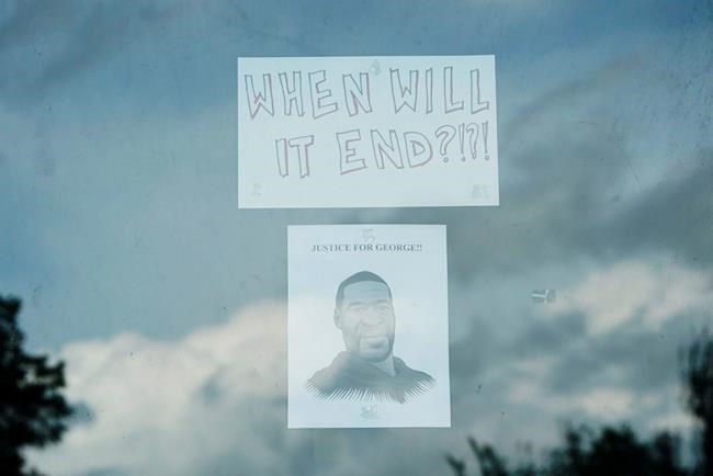 An illustration of George Floyd is affixed to the window of a vacant building Tuesday, May 26, 2020, near where he was detained by police officers in Minneapolis. Floyd died after being restrained by Minneapolis police officers on Memorial Day. A video taken by a bystander shows a Minneapolis police officer with his knee on the neck of a man in custody who later died. The four officers involved have been fired. (Evan Frost/Minnesota Public Radio via AP)