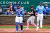Chicago White Sox's Andrew Vaughn runs between Kansas City Royals catcher Salvador Perez and pitcher Jakob Junis (24) to score on a single by Leury Garcia during the sixth inning of a baseball game Sunday, May 9, 2021, in Kansas City, Mo. (AP Photo/Charlie Riedel)