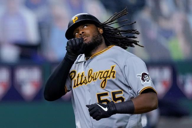 Pittsburgh Pirates' Josh Bell celebrates as he crosses the plate after hitting a two-run home run during the eighth inning of the team's baseball game against the Kansas City Royals on Friday, Sept. 11, 2020, in Kansas City, Mo. (AP Photo/Charlie Riedel)