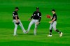 Chicago White Sox outfielders Eloy Jimenez (74), Luis Robert (88) and Adam Engel celebrate after their baseball game against the Kansas City Royals, Saturday, Aug. 1, 2020, in Kansas City, Mo. (AP Photo/Charlie Riedel)