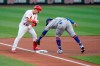 St. Louis Cardinals' Tommy Edman, left, arrives at third for a triple ahead of the tag from New York Mets third baseman Jonathan Villar during the first inning of a baseball game Monday, May 3, 2021, in St. Louis. (AP Photo/Jeff Roberson)