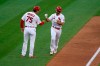 St. Louis Cardinals' Paul DeJong, right, is congratulated by third base coach Ron 'Pop' Warner (75) after hitting a two-run home run during the fifth inning in the first game of a baseball doubleheader against the New York Mets Wednesday, May 5, 2021, in St. Louis. (AP Photo/Jeff Roberson)