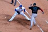 Miami Marlins' Garrett Cooper (26) grounds out as Chicago Cubs first baseman Anthony Rizzo handles the throw during the ninth inning in Game 2 of a National League wild-card baseball series Friday, Oct. 2, 2020, in Chicago. (AP Photo/Nam Y. Huh)