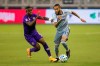 FILE - Sporting Kansas City defender Amadou Dia (13) attempts to maneuver past the defense of Orlando City midfielder Sebas Mendez (8) during an MLS soccer game in Kansas City, in this Wednesday, Sept. 23, 2020, file photo. Major League Soccer has extended its deadline for negotiating adjustments to the existing collective bargaining agreement until Feb. 4 and warned it is prepared to lock out players if a deal isn't reached by then. (Nick Tre. Smith/The Kansas City Star via AP, File)