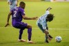 Sporting Kansas City forward Gerso (12) attempts to fend off Orlando City defender Ruan (2) during an MLS soccer game, Wednesday, Sept. 23, 2020 at Children's Mercy Park in Kansas City, Kan. (Nick Tre. Smith/The Kansas City Star via AP)