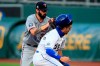 Kansas City Royals Whit Merrifield, right, is tagged out by Minnesota Twins starting pitcher Devin Smeltzer, left, during a rundown in the first inning of a baseball game at Kauffman Stadium in Kansas City, Mo., Friday, Aug. 7, 2020. (AP Photo/Orlin Wagner)