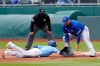 Kansas City Royals Nicky Lopez, left, dives back safely ahead of the tag by Toronto Blue Jays first baseman Rowdy Tellez, right, during the second inning of a baseball game at Kauffman Stadium in Kansas City, Mo., Sunday, April 18, 2021. (AP Photo/Orlin Wagner)