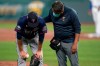 Minnesota Twins starting pitcher Jake Odorizzi, left, is checked on by a trainer after getting hit by a batted ball during the fourth inning of a baseball game against the Kansas City Royals at Kauffman Stadium in Kansas City, Mo., Friday, Aug. 21, 2020. Odorizzi left the game. (AP Photo/Orlin Wagner)