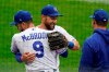 Kansas City Royals left fielder Alex Gordon, middle, is hugged by teammate Ryan McBroom (9) after being taken out of a baseball game against the Detroit Tigers during the second inning at Kauffman Stadium in Kansas City, Mo., Sunday, Sept. 27, 2020. It was Gordon's last game as a Royal. (AP Photo/Orlin Wagner)
