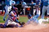 Kansas City Royals Whit Merrifield (15) beats the tag by Texas Rangers catcher Jose Trevino, left, during the sixth inning of a baseball game at Kauffman Stadium in Kansas City, Mo., Saturday, April 3, 2021. (AP Photo/Orlin Wagner)