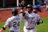 Chicago White Sox designated hitter Edwin Encarnacion (23) is congratulated by teammate Yasmani Grandal (24) after his three-run home run during the seventh inning of a baseball game against the Kansas City Royals at Kauffman Stadium in Kansas City, Mo., Sunday, Sept. 6, 2020.(AP Photo/Orlin Wagner)