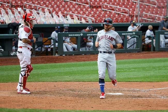 St. Louis Cardinals catcher Yadier Molina (4) watches as Cleveland Indians' Mike Freeman scores a run during the 12th inning of a baseball game, Saturday, Aug. 29, 2020, in St. Louis. (AP Photo/Scott Kane)