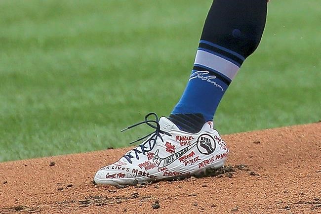 St. Louis Cardinals starting pitcher Jack Flaherty (22) wears cleats supporting the Black Lives Matter movement during the first inning of a baseball game against the Cleveland Indians, Saturday, Augf. 29, 2020, in St. Louis. (AP Photo/Scott Kane)