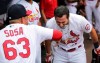 St. Louis Cardinals' Paul DeJong (11) gets a face full of water from Edmundo Sosa (63) as they celebrate DeJong's solo home run in the third inning of a baseball game against the San Francisco Giants, Sunday, July 18, 2021, in St. Louis. (AP Photo/Tom Gannam)