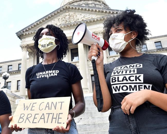 Protesters, who did not wish to be identified, chant outside the Mississippi State Capitol building in Jackson, Miss. on Friday afternoon following comments made by Petal Mayor Hal Marx regarding the death of George Floyd on Monday in Minneapolis. Friday, May 28, 2020. (Sarah Warnock/The Clarion-Ledger via AP)