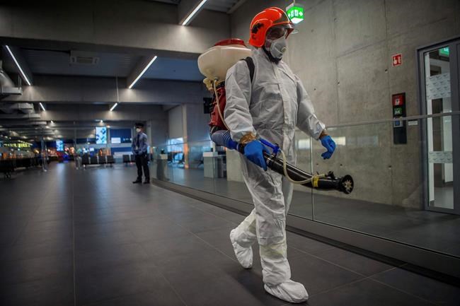 Disinfection equipment is carried by a worker as precautionary measures against the spreading of novel coronavirus, at Budapest Liszt Ferenc International Airport in Budapest, Hungary, Wednesday, Feb. 5, 2020. So far almost 900 passenger arriving directly from China have been examined at the airport. (Zoltan Balogh/MTI via AP)