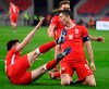 Robert Lewandowski of Poland, right, celebrates after scoring the third goal against Hungary during the FIFA World Cup 2022 qualifying soccer match between Hungary and Poland in the Puskas Ferenc Arena in Budapest, Hungary, Thursday, March 25, 2021. (Zsolt Szigetvary/MTI via AP)