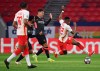 RB Leipzig's Nordi Mukiele, right, tries to get past Liverpool's Roberto Firmino, center, during the Champions League round of 16, first leg, soccer match between RB Leipzig and Liverpool in the Puskas Ferenc Arena in Budapest, Hungary, Tuesday, Feb. 16, 2021. At right Lukas Klostermann of RB Leipzig. (Tibor Illyes/MTI via AP)