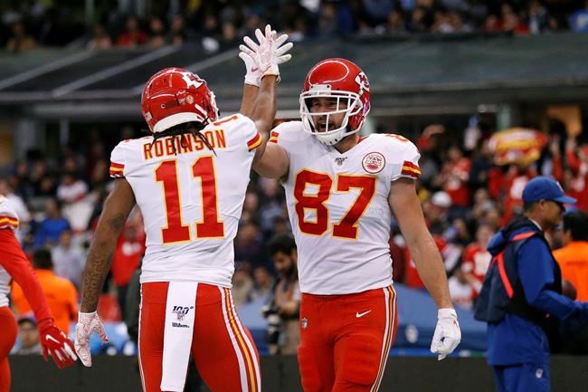 Kansas City Chiefs tight end Travis Kelce, right, celebrates with teammate wide receiver Demarcus Robinson after scoring a touchdown during the second half of an NFL football game against the Los Angeles Chargers, Monday, Nov. 18, 2019, in Mexico City. (AP Photo/Rebecca Blackwell)
