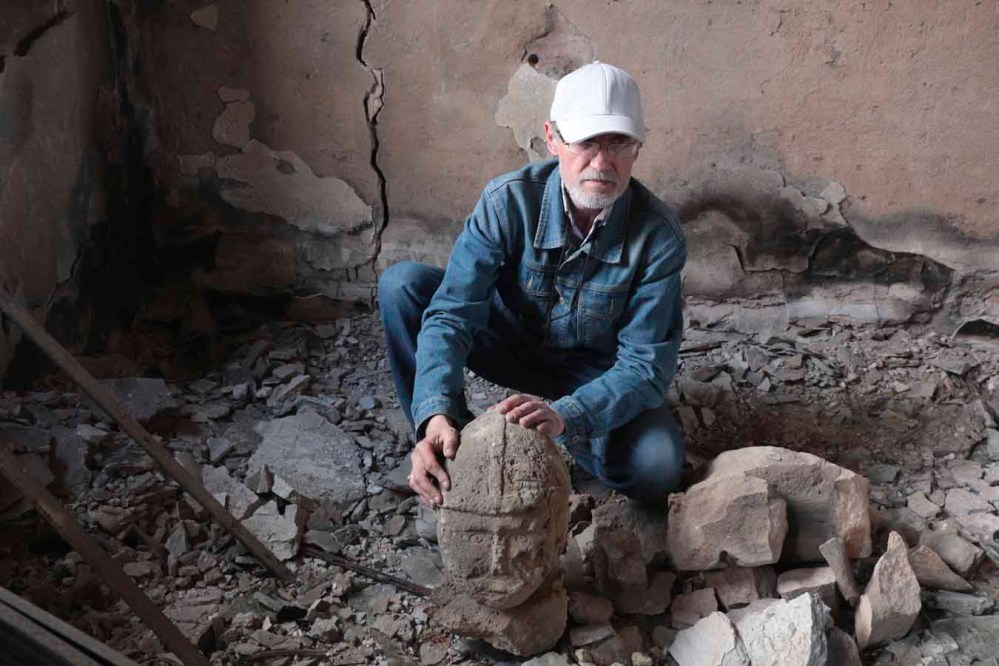 AP
A restorer examines the broken exhibits in Mariupol’s Museum of Local Lore, which burned down after the shelling in an area controlled by Russian-backed separatist forces. (The Associated Press)