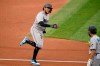 Miami Marlins' Miguel Rojas, left, reacts after rounding third base on his three-run home run during the second inning of a baseball game against the Washington Nationals, Friday, Aug. 21, 2020, in Washington. Marlins third base coach Trey Hillman, right, looks on. (AP Photo/Nick Wass)