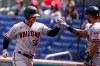 Arizona Diamondbacks' Kole Calhoun, left, celebrates his solo home run with David Peralta during the third inning of a baseball game against the Washington Nationals at Nationals Park, Saturday, April 17, 2021, in Washington. (AP Photo/Alex Brandon)
