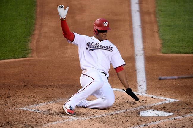 Washington Nationals' Juan Soto slides home to score on a single by Josh Harrison during the third inning of the team's baseball game against the Tampa Bay Rays, Tuesday, Sept. 8, 2020, in Washington. (AP Photo/Nick Wass)