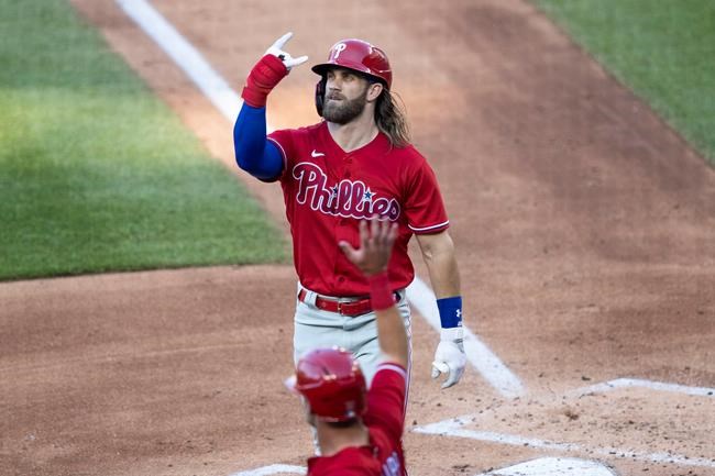 Philadelphia Phillies' Bryce Harper celebrates his three-run homer during the second inning of an exhibition baseball game against the Washington Nationals at Nationals Park, Saturday, July 18, 2020, in Washington. (AP Photo/Alex Brandon)