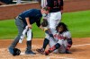 Atlanta Braves' Ronald Acuna Jr., grimaces as he is helped after fouling the ball off his left foot during the fourth inning of the team's baseball game against the Washington Nationals in Washington, Friday, Sept. 11, 2020. Acuna was helped off the field. (AP Photo/Manuel Balce Ceneta)