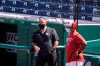 CORRECTS FIRST NAME TO MIKE-Washington Nationals general manager Mike Rizzo, left, and manager Dave Martinez, watch the team during a baseball workout at Nationals Park, Monday, April 5, 2021, in Washington. The Nationals are scheduled to play the Braves on Tuesday. (AP Photo/Alex Brandon)