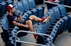 Washington Nationals starting pitcher Max Scherzer sits in the stands and watches the baseball team's training camp workout at Nationals Park, Tuesday, July 14, 2020, in Washington. (AP Photo/Alex Brandon)