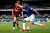 Everton's Richarlison, right, kicks the ball past Bournemouth's David Brooks during the English Premier League soccer match between Everton and Bournemouth at Goodison Park in Liverpool, England Sunday, July 26, 2020. (Clive Brunskill/Pool via AP)