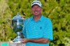 Jim Herman holds the championship trophy after winning the final round of the Wyndham Championship golf tournament at Sedgefield Country Club on Sunday, Aug. 16, 2020, in Greensboro, N.C. (AP Photo/Chris Carlson)