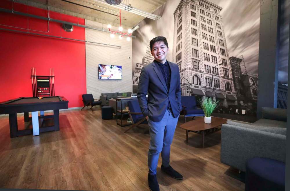photos by RUTH BONNEVILLE / WINNIPEG FREE PRESS
Regional leasing team lead Justin Sumagui checks out an expansive, rec-room-style foyer in the former Medical Arts Building. The project won the award of Renovation of the Year from the Canadian Federation of Apartment Associations.
